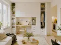Ett hem med skandinavisk design. En soffa, ett runt soffbord och en inbyggd möbel med skrivbord, förvaring och garderob.