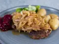 En tallrik med pannbiff, stekt lök, lingonsylt och kokt potatis. Ett klassiskt svenskt pannbiff recept som är lätt att lyckas med.