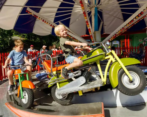 Barn njuter av en motorcykelkarusell på Tivoli Oslo.